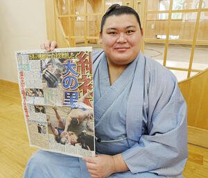一夜明け会見を終え優勝を報じた本紙を手にする大の里(撮影･小沢裕)