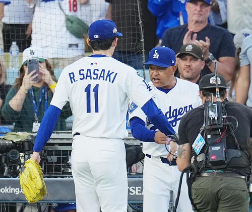 地区シリーズ･ドジャース対フィリーズ　10回の投球を終え、ロバーツ監督(右)に迎えられる佐々木(撮影･菅敏)