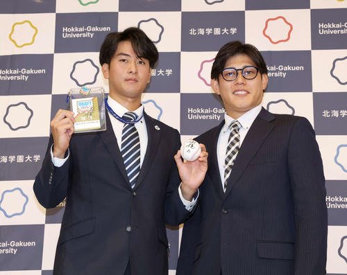 オリックスから5位指名された北海学園大の高谷(左)は佐野アマチュアスカウトから指名あいさつをうけ笑顔(撮影･黒川智章)