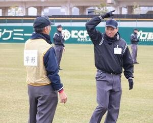 中学野球の審判(左)が日本高野連所属の審判にジェスチャーを教わる(撮影･林亮佑)