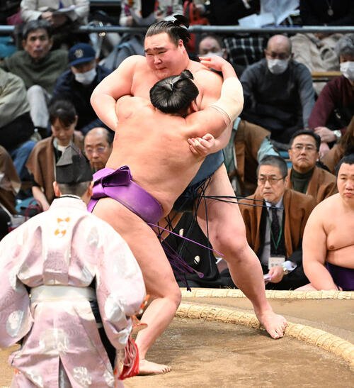 白熊(奥)を寄り切りで破る尊富士(撮影･和賀正仁)