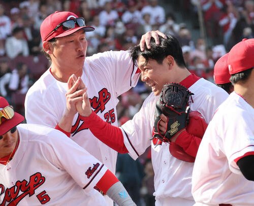 広島対中日　新井監督(左)に迎えられるマダックス1安打完封勝利を決めた栗林(撮影･加藤孝規)