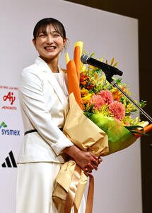 引退会見で結婚を発表した坂本花織は花束を手に笑顔を見せる(撮影･上田博志)