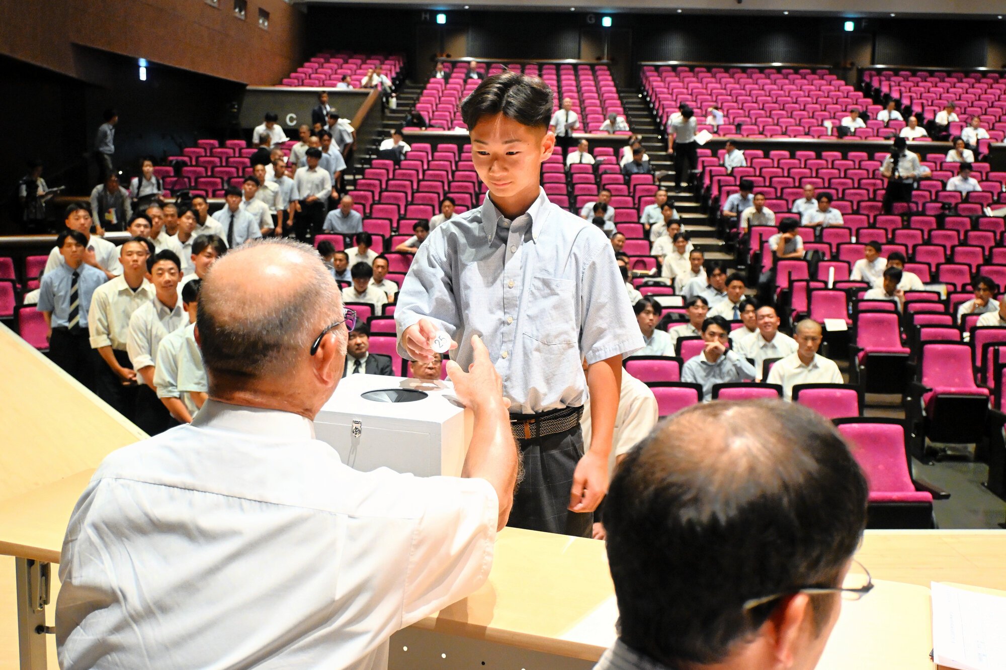 抽選でくじをひく各校の主将=2026年6月24日午後2時42分、福島県須賀川市の須賀川しんきん文化センター、荒川公治撮影
