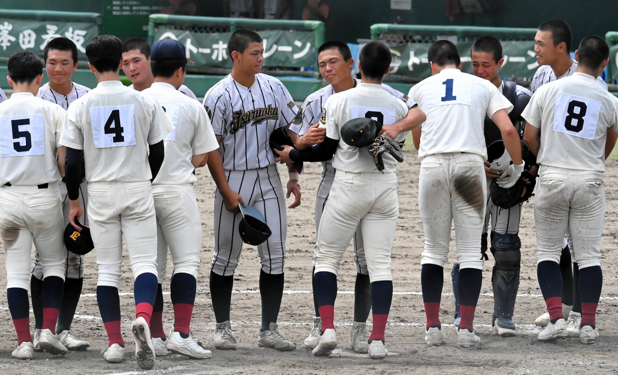 決勝を終えて健闘をたたえ合う、鶴岡東と東北文教大山形城北の選手たち=2026年7月27日、ヤマリョー、渡部耕平撮影
