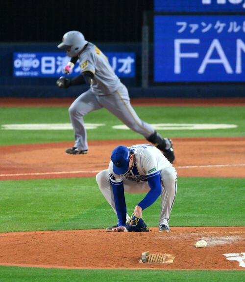 DeNA対阪神　9回表阪神2死二、三塁、森下翔太(後方)に2点適時打を許ししゃがみ込むショーン･レイノルズ(撮影･滝沢徹郎)