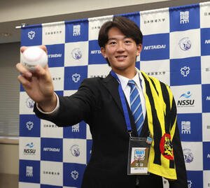 指名あいさつの後、阪神2位指名の日体大･馬場拓海はポーズを決める(撮影･柴田隆二)