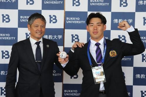 担当の早川大輔スカウト(左)と写真に納まる、オリックスのドラフト5位･佛教大の野村亮輔(撮影･中島麗)